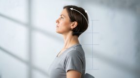 Person performing chin tuck exercise demonstrating proper neck alignment and posture correction technique