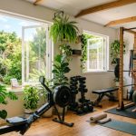 Bright home gym with open windows, indoor plants, and natural cross-ventilation creating a fresh training environment
