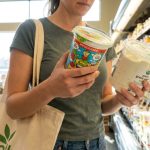 Why Health-Conscious Buyers in Seattle, WA Avoid Certain Processed Yogurts Health-conscious shopper reading yogurt ingredients in Seattle grocery store