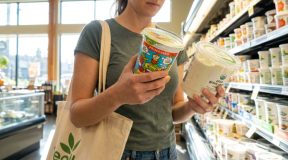 Health-conscious shopper reading yogurt ingredients in Seattle grocery store