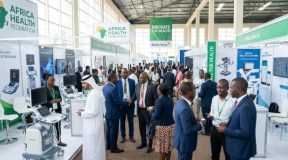 Healthcare professionals networking at an Africa healthcare expo exhibition floor with medical device displays