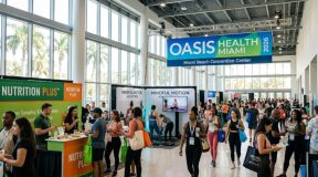 Visitors exploring health and wellness exhibitor booths at the Oasis Health Expo Miami 2026 at the Miami Beach Convention Center
